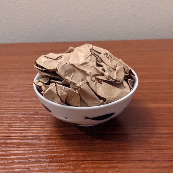 Crumpled brown paper in a small bowl