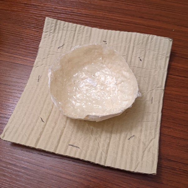 Bowl inverted, on cardboard
