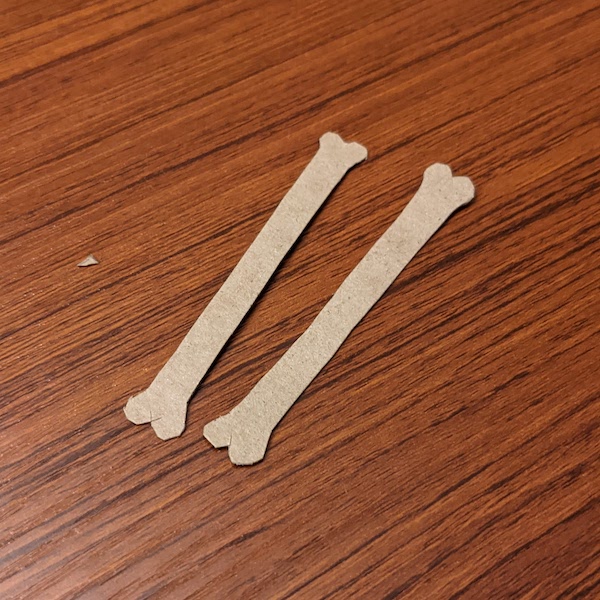 Two bone-shaped pieces of cardstock